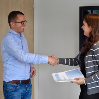 Two people shaking hands in an office