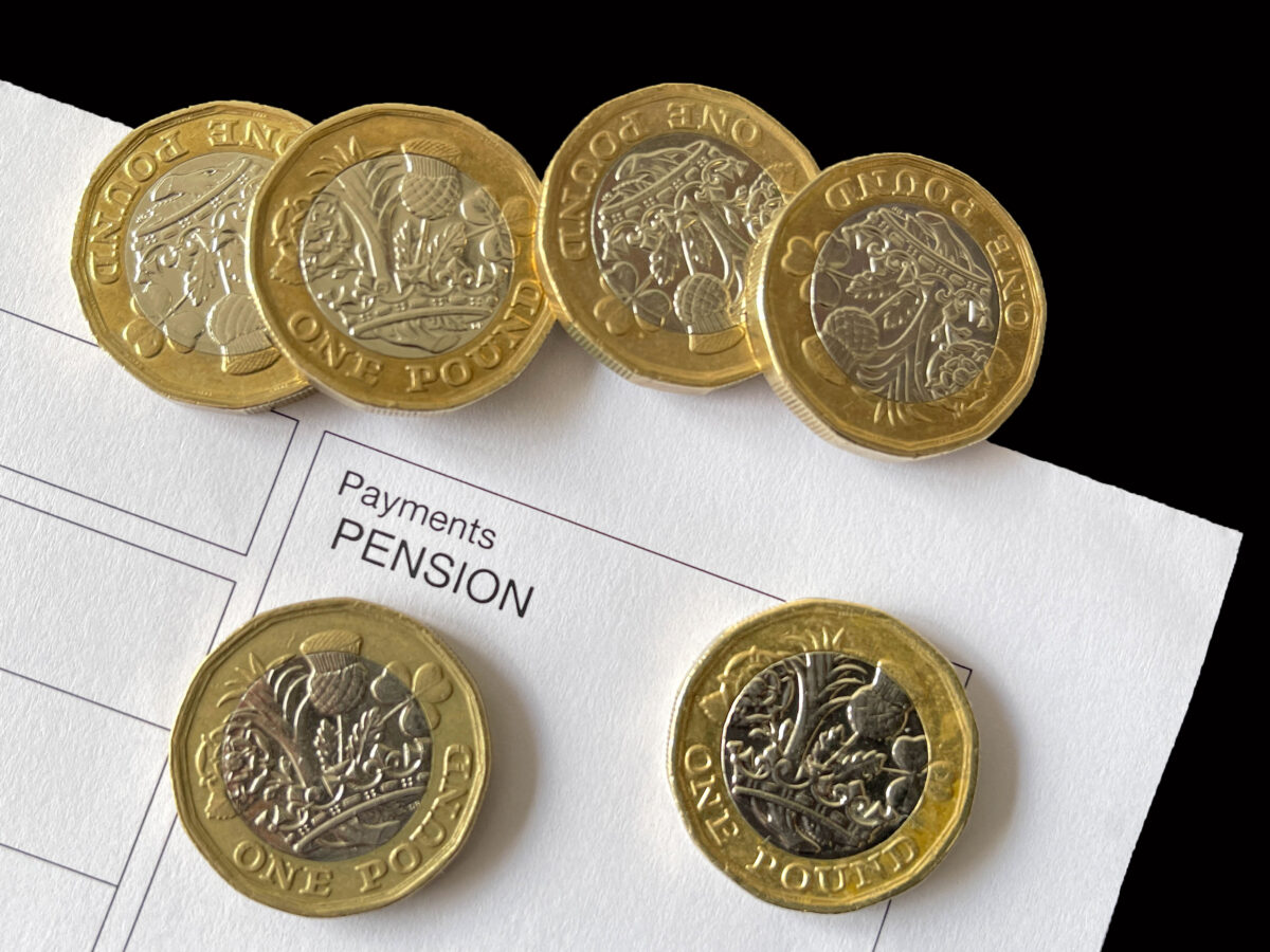 Pound coins on a pension payments document